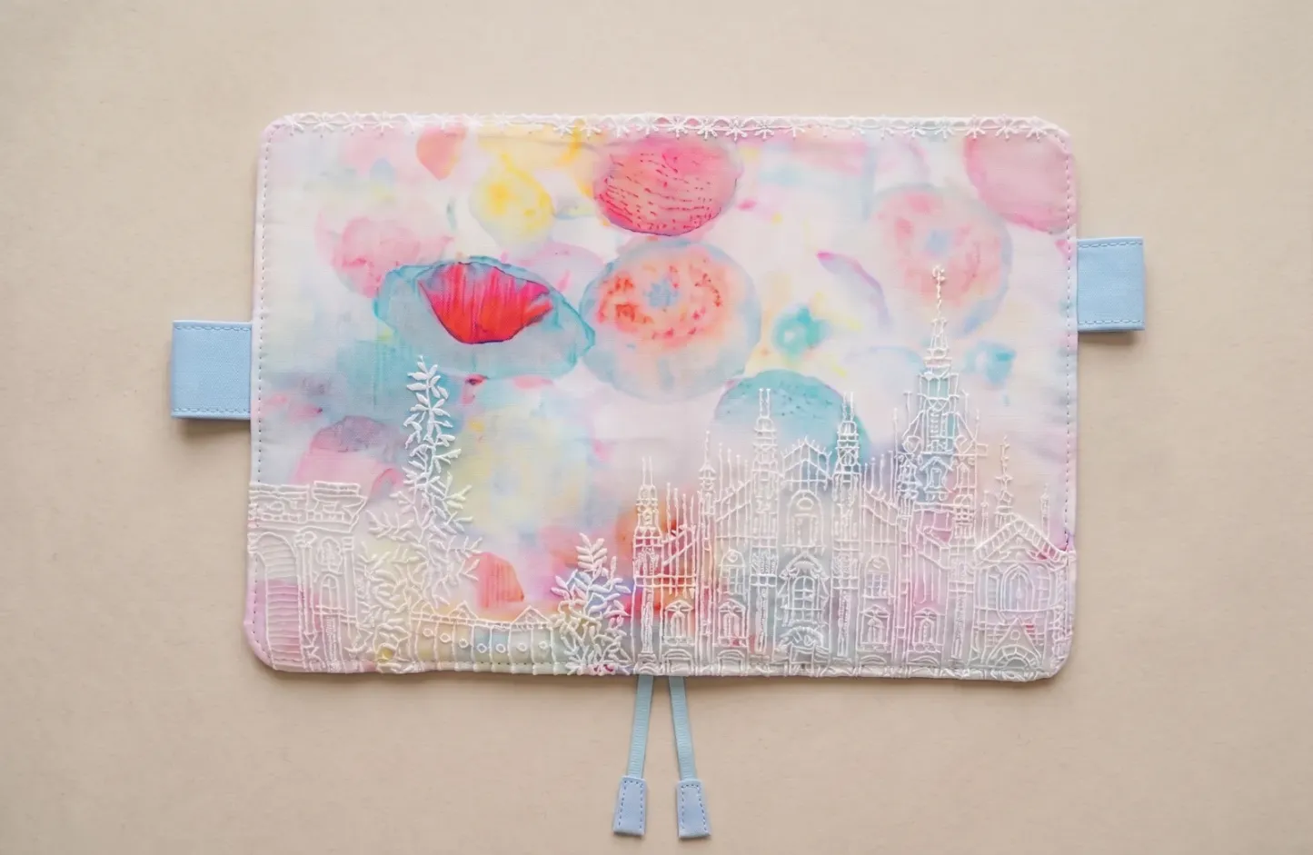 Pastel floral castle embroidered fabric cover shown flat