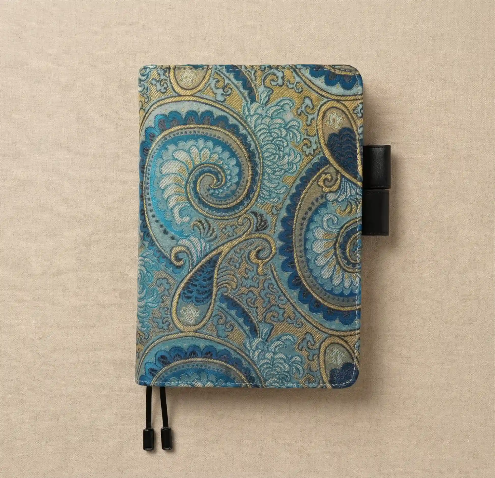 Flatlay of a premium A5 size planner cover fit for Hobonichi Cousin, featuring signature double pen loops.