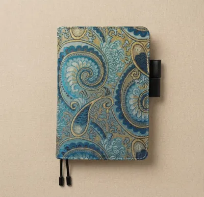 Flatlay of a premium A5 size planner cover fit for Hobonichi Cousin, featuring signature double pen loops.