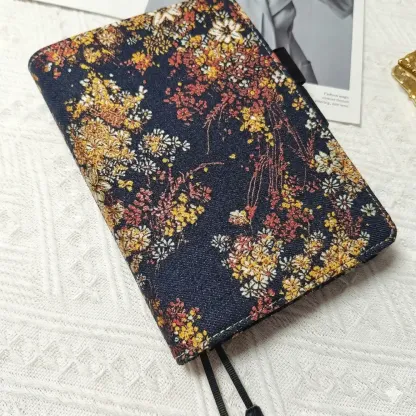 A 45-degree angle shot of the navy floral journal cover that fits A5 Hobonichi Cousin. The image highlights the premium tactile texture of the fabric and the precision stitching along the edges.