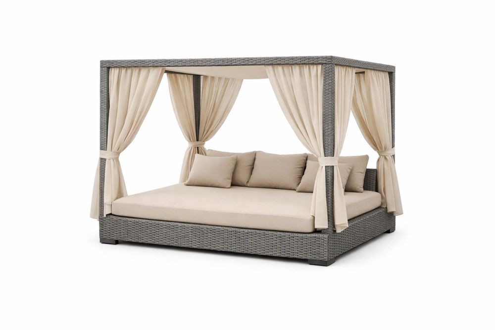 Outdoor wicker daybed with beige cushions and curtains
