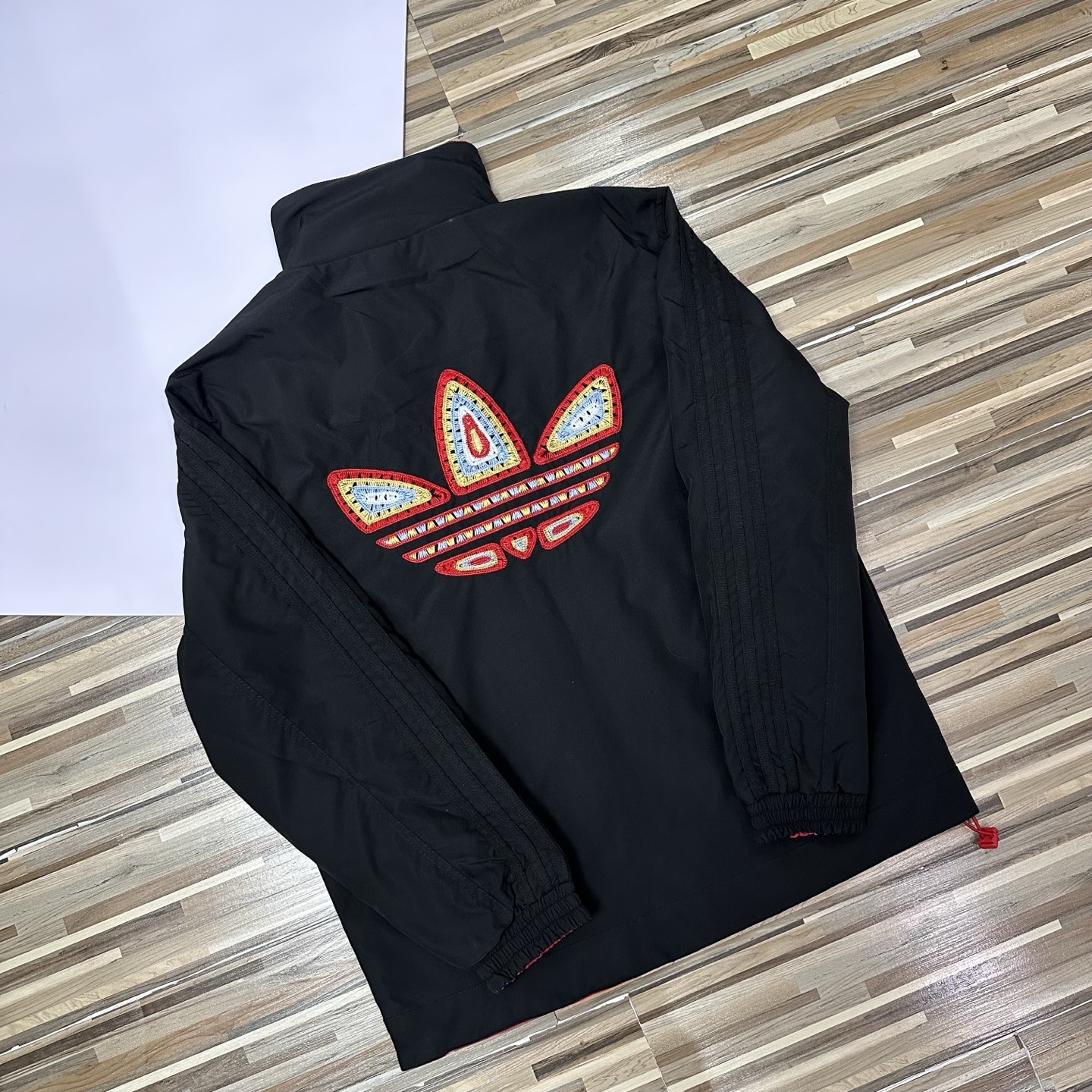 春秋季新款男士夾克外套女士外套夾克雙面穿外套紅色外套阿迪達斯三葉草外套三條槓夾克）
阿迪達斯 Adidas 三葉草兩面穿外套 
​黑紅撞色的外套在秋冬里超吸睛
​設計簡直是性價比王炸，雙面雙風格隨便切換，黑面走復古運動風，紅白條紋領撞色吸睛，側邊編織紋路藏滿細節

後背還有彩色刺繡三葉草，潮得毫不費力，紅面是經典白條紋款，簡約亮眼還巨顯白，
做工細節直接拿捏，全身細密鎖邊走線，針腳勻得找不出一根歪線，側邊編織紋路是規整手工走線，穿再久都不會松垮開線，

五金輔料更是誠意滿滿，領口織帶包边厚实挺
