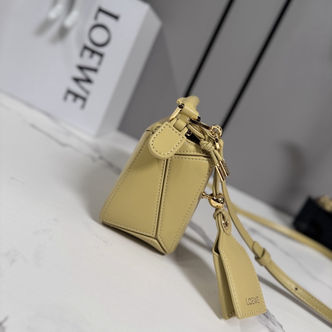 LO℮w℮🌟新款 迷你納帕羊皮革 Featherlight Puzzle 手袋 以別具一格的幾何線條勾勒長方體造型。柔軟輕盈的納帕皮革為手袋注入隨性慵懶的風格。可肩背、斜挎或手提
可拆卸可調節肩帶，飾有旋轉卡扣*拉鍊開合，鉸接式拉鍊頭 一個外部拉鍊後袋，一個內部插袋*可拆卸 LOE**WE 燙金或燙銀標籤，飾有隱秘口袋和氣球骰子*長方形金屬腳釘 納帕羊皮革襯里 Anagram 壓紋、飾牌內部鐫刻 LOE**WE.
型號：062511
size:17.5*7.5*12.5CM（配全套包裝）