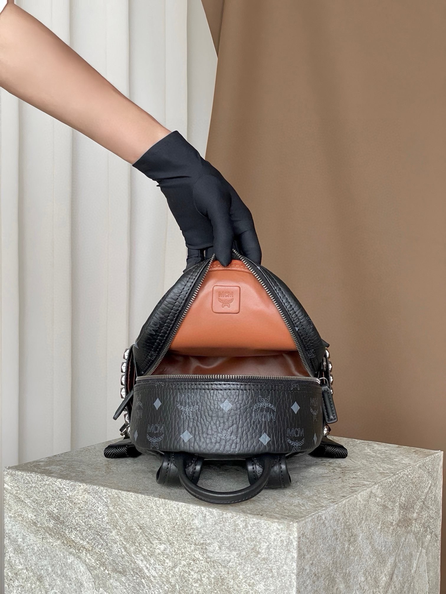 𝐌𝐂𝐌 𝐒𝐭𝐚𝐫𝐤 𝐕𝐢𝐬𝐞𝐭𝐨𝐬，𝐌𝐢𝐧𝐢 铆钉双肩背包黑色这款迷你 Stark 双肩背包是一款可以彰显独特风格的小配饰。MCM 经典款的缩小版本采用我们标志性的 Visetos 涂层帆布制成，配以奢华的人造皮革衬里和铆钉饰边