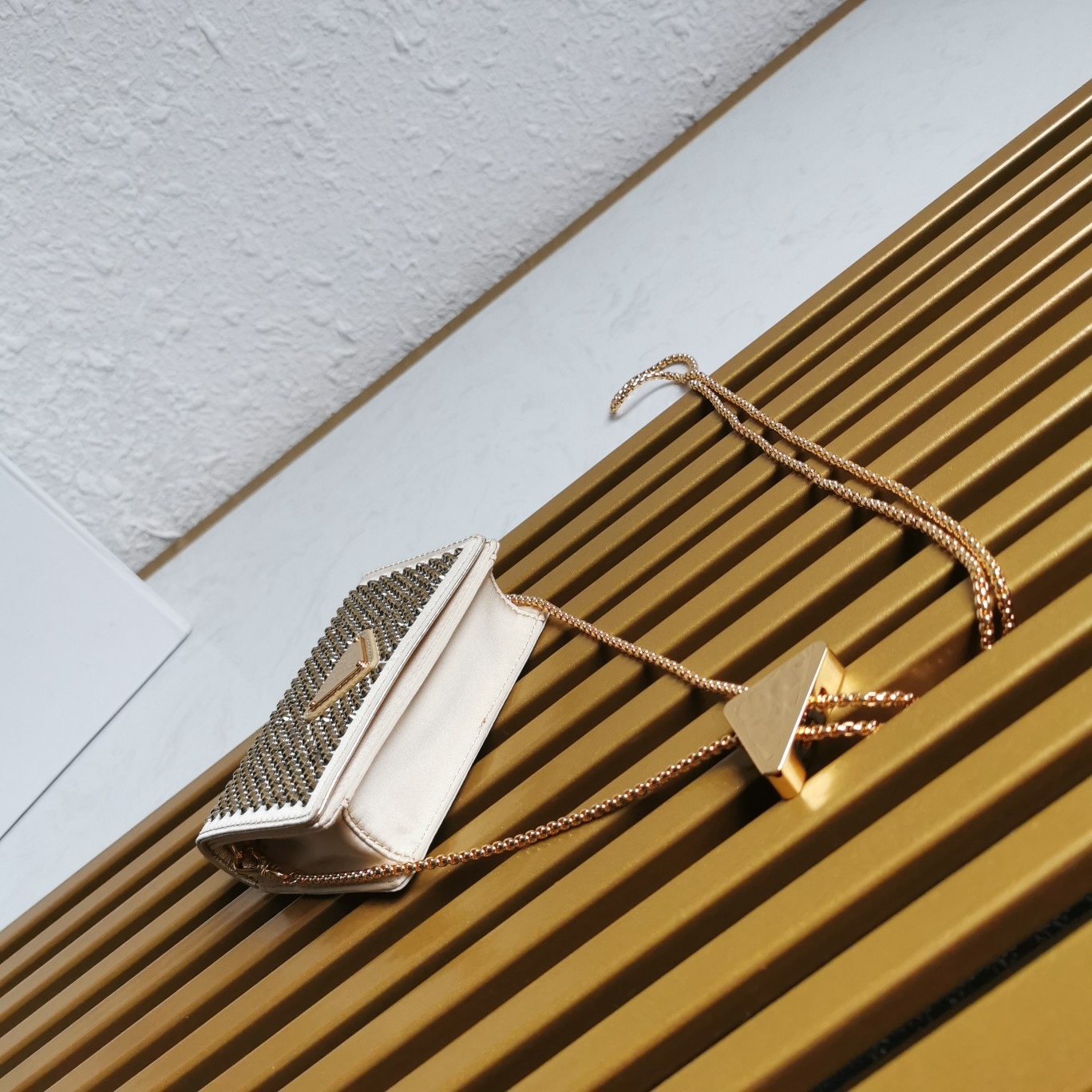 【 原單】🎉2023新款金色系項鍊水晶小包🎉1MR024🎉🎉這款Duchesse面料卡片夾通體飾以仿水晶，於表面營造出光影格調和虹彩炫色，彰顯華美且不失功能性的設計。最愛是這條可拆卸可調節鐵璉肩帶，又可當腰包裝飾😍😍又可當搭配衣服項鍊裝飾，中間三角形標可調節活動，賦予單品多樣的佩戴方式。空間可裝口紅💄/耳機/鑰匙🚗....夜燈下bling bling,太美了。值得入手🎉🎉尺寸：長11.5cm*高8cm