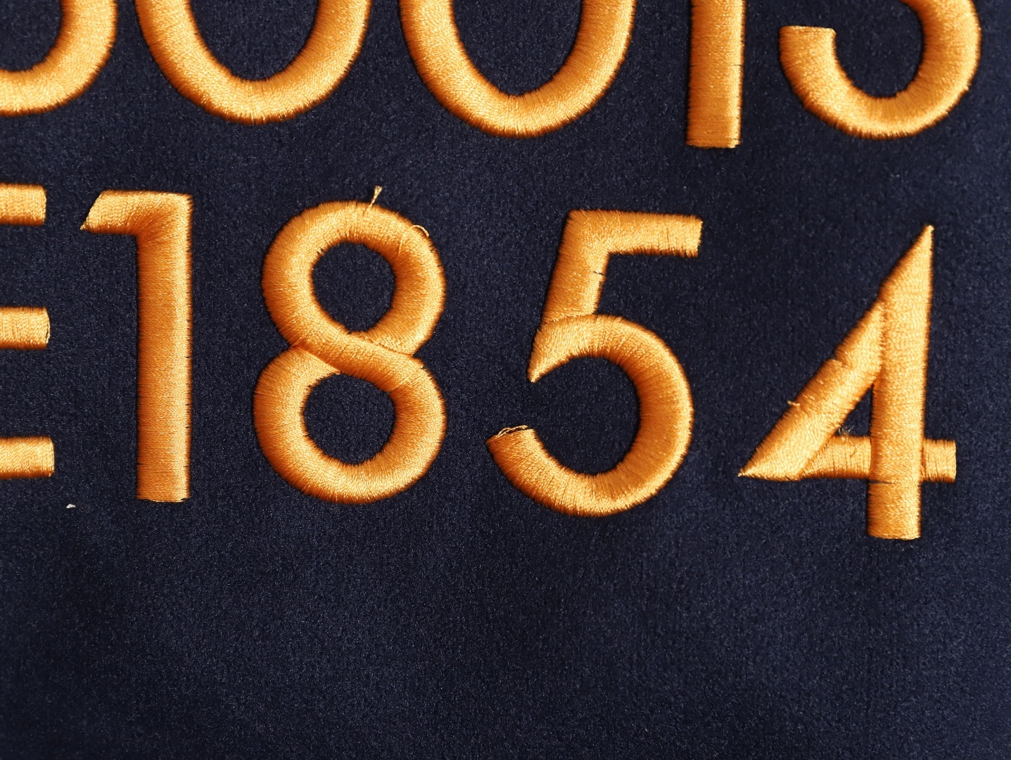 Louis Vuitton/路易威登 26ss 水鑽刺繡棒球服外套
材質拼接：衣身採用藏青色羊毛混紡面料，質感挺括耐磨；袖子為淺棕牛皮材質，柔軟細膩，經典拼皮設計還原美式棒球服復古感。

• 裝飾亮點：左胸位置有重工水鑽+金屬刺繡裝飾，鑲嵌多色寶石與閃鑽，綴有“L.V.M.”字母標識，華麗精緻，辨識度拉滿。

• 版型結構：立領+羅紋條紋領口/袖口/下擺，防風且修飾身形；正面按扣開合，兩側配有插袋，兼顧實用與美觀。
球帽點綴，休閒隨性又有街頭感。
N Size:S-XL