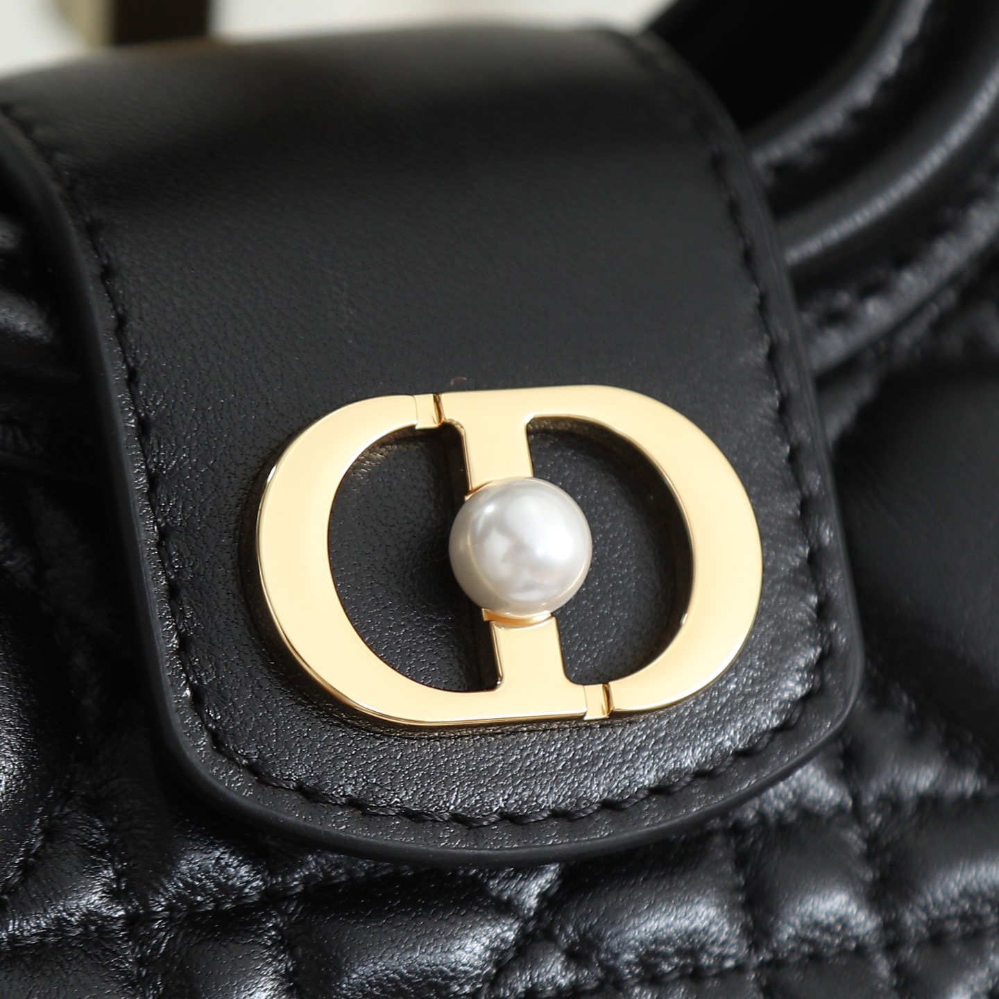 原廠級 黑色鏈條手袋
這款 Dior Jolie Top Handle 迷你鏈條手袋是二零二六早春成衣系列新品，呈現出優雅精緻的設計。採用黑色羊皮革精心製作，飾以藤格紋，翻蓋點綴以金色飾面金屬 CD 標誌和白色樹脂珠飾。內設一個隔層，可收納各種日常用品。搭配雙頂部手柄和可調節、可拆卸 CD 鏈條肩帶，肩帶由皮革帶和 CD 鏈環組成，飾以白色樹脂珠飾，可舒適手提、肩背或斜挎，可與日常或晚裝造型搭配。
