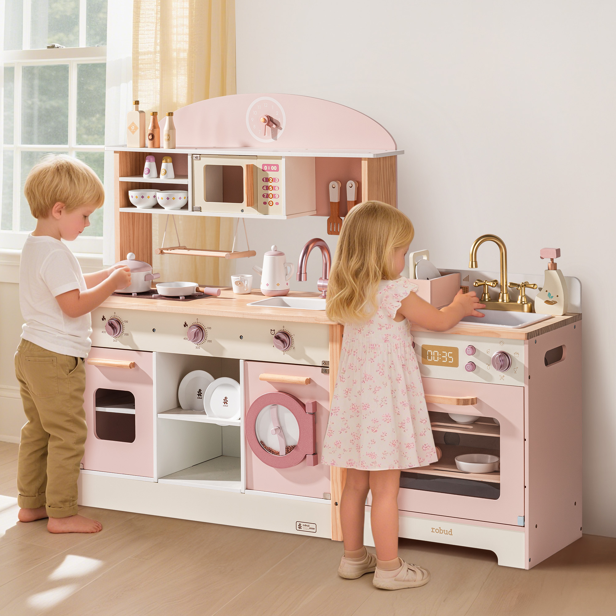 Children enjoying imaginative play with the pink kitchen set