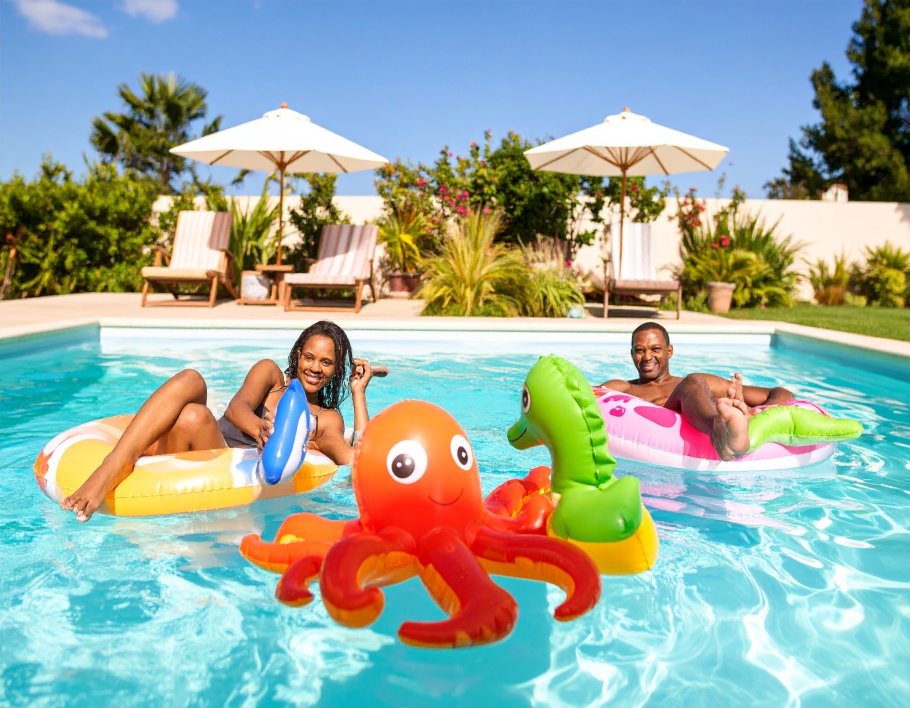 Firefly-A-sunny-backyard-pool-with-adults-using-the-Mini-Inflatable-Sea-Toy-Set-each-holding-302143