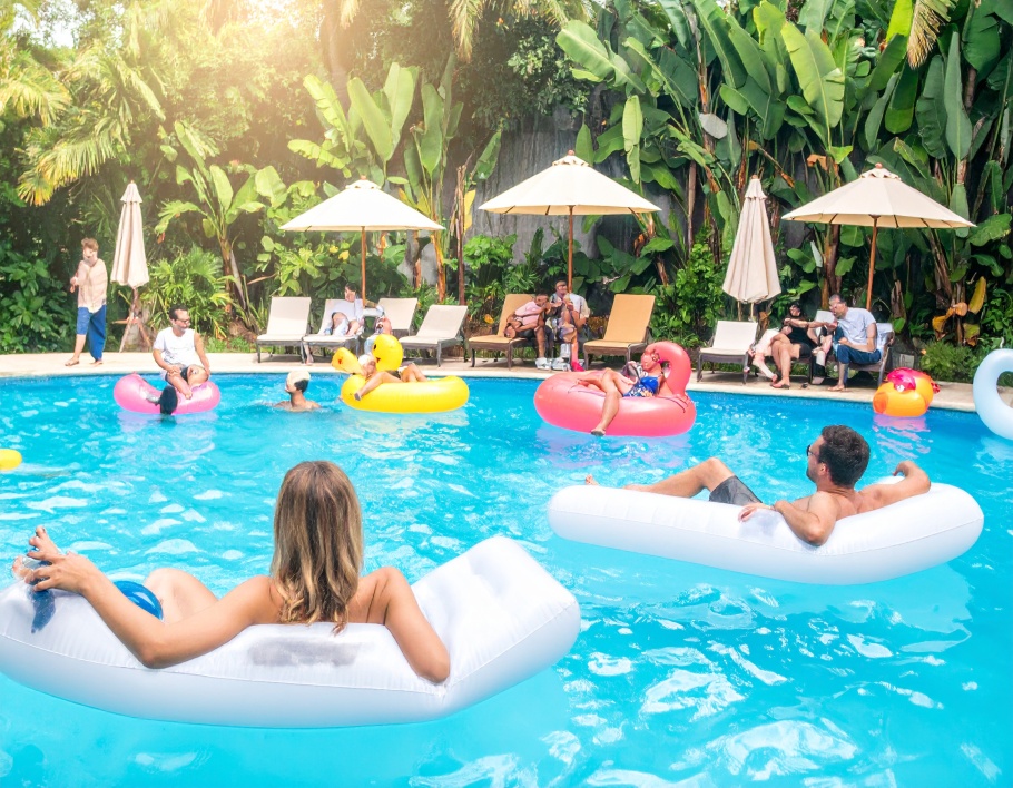 Firefly-Fun-summer-pool-party-with-adults-floating-on-rectangular-inflatable-loungers-bright-761834
