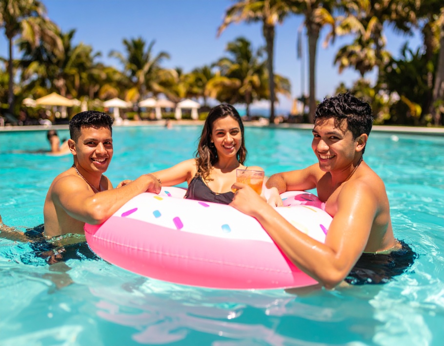 Firefly-Three-young-adults-enjoying-a-sunny-pool-afternoon-on-a-pink-sprinkle-patterned-infla-682453