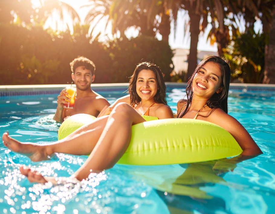 Firefly-Three-young-adults-enjoying-a-sunny-pool-day-on-a-lime-colored-inflatable-circular-fl-682453