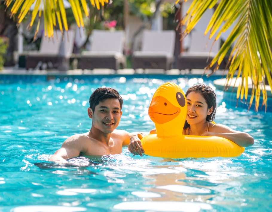 Firefly-Two-young-adults-floating-on-a-large-bright-yellow-inflatable-duck-shaped-pool-float-108357