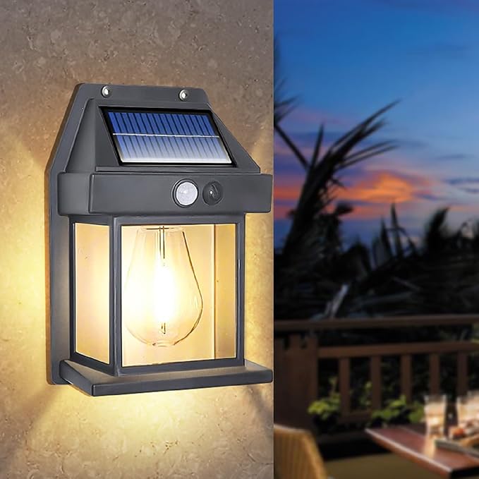 Solar lantern wall light glowing beside an outdoor seating area