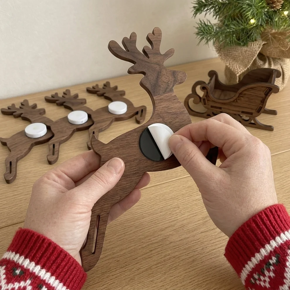 Close-up of press-on backing being applied to reindeer piece