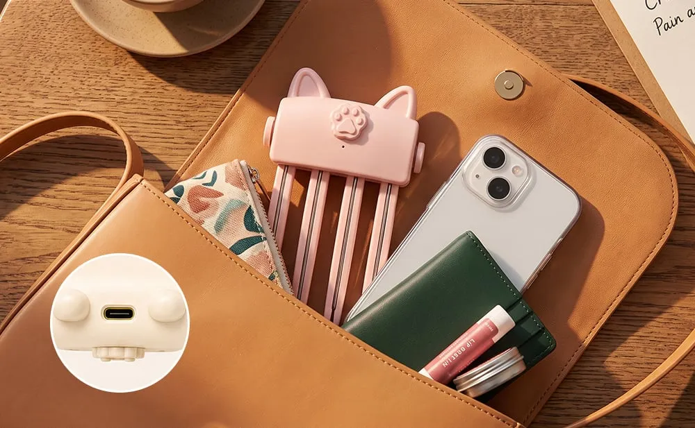 Compact pink USB rechargeable heated root comb in handbag