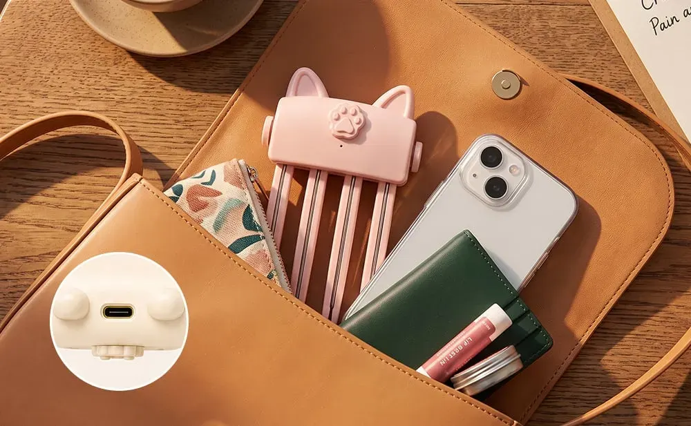 Compact pink USB rechargeable heated root comb in handbag