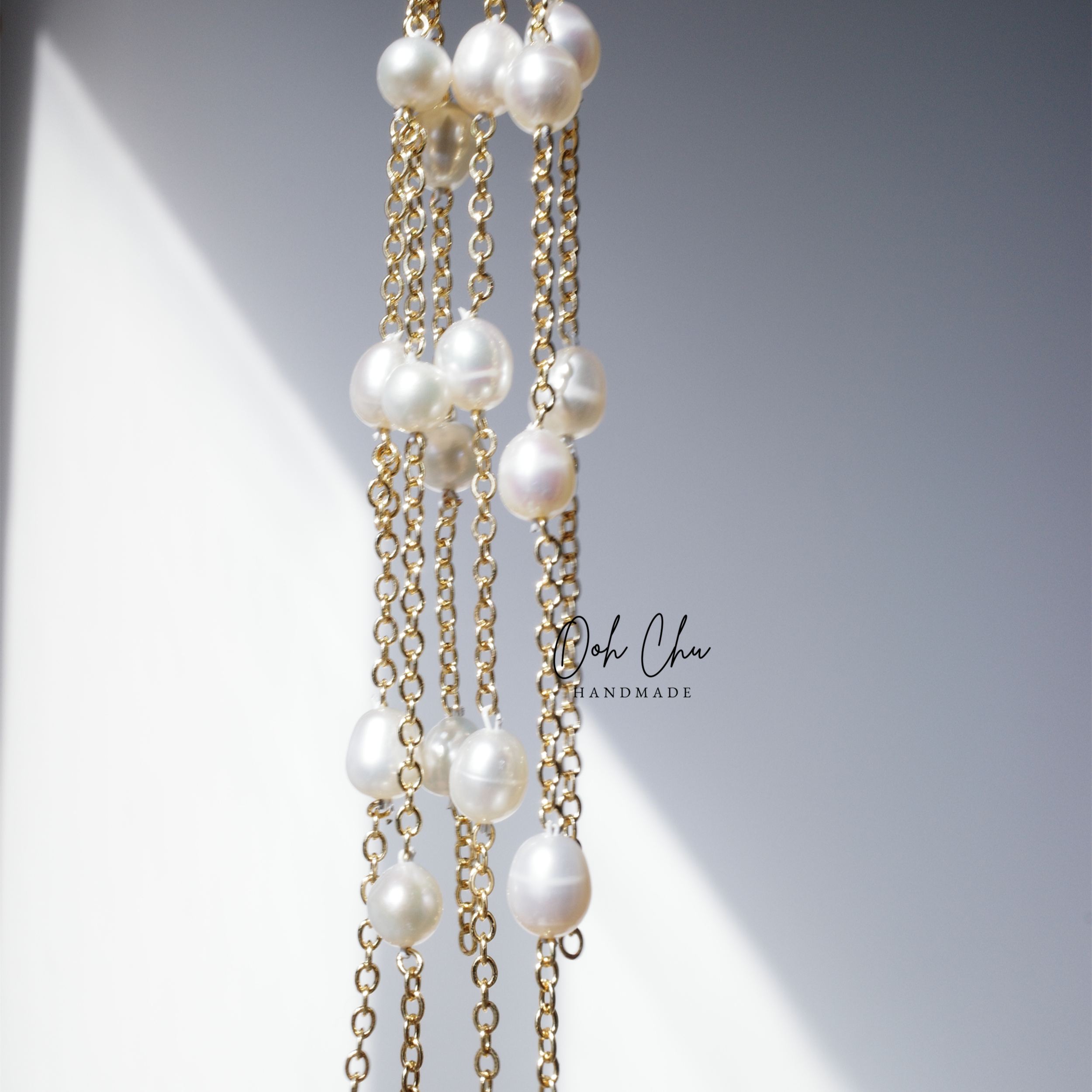 pearl tassel earrings reflecting sunlight soft movement like water ripples elegant calming aesthetic jewelry