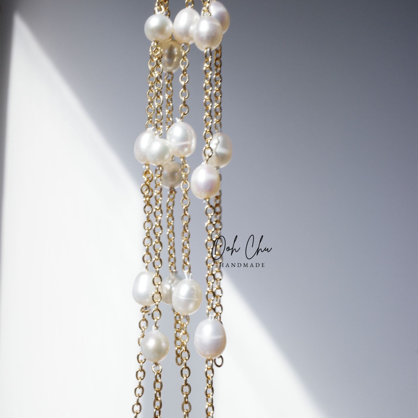 pearl tassel earrings reflecting sunlight soft movement like water ripples elegant calming aesthetic jewelry