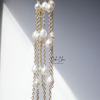 pearl tassel earrings reflecting sunlight soft movement like water ripples elegant calming aesthetic jewelry