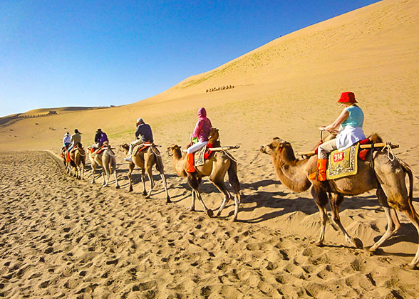 Riding the Camel in Kumtag Desert