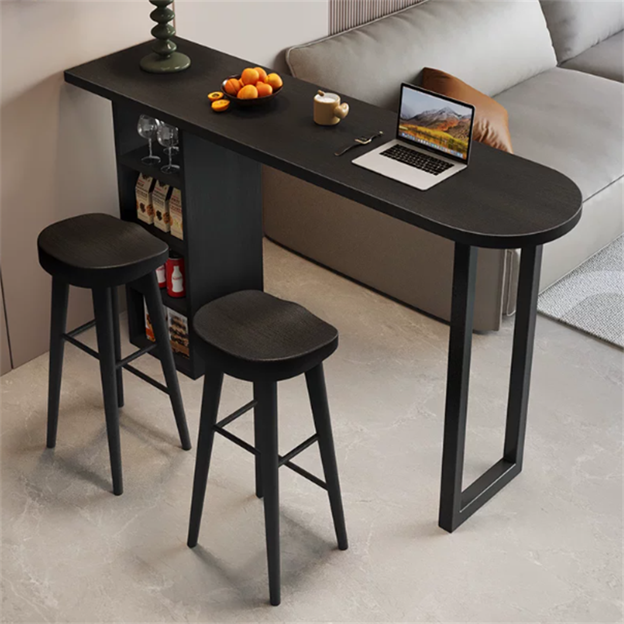 Black solid wood bar table with open storage in a living room; stools sold separately