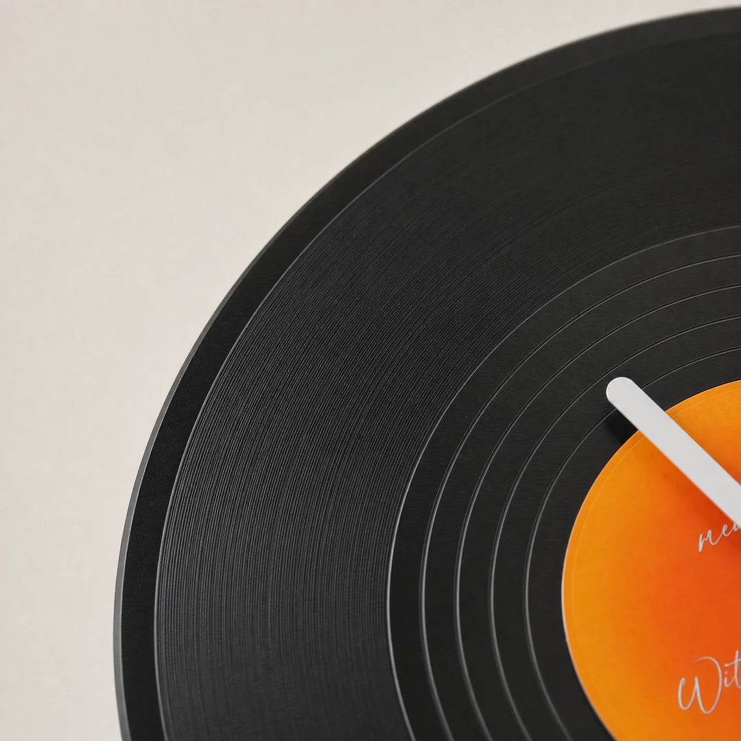 Retro vinyl desktop clock close-up showing vinyl groove texture detail
