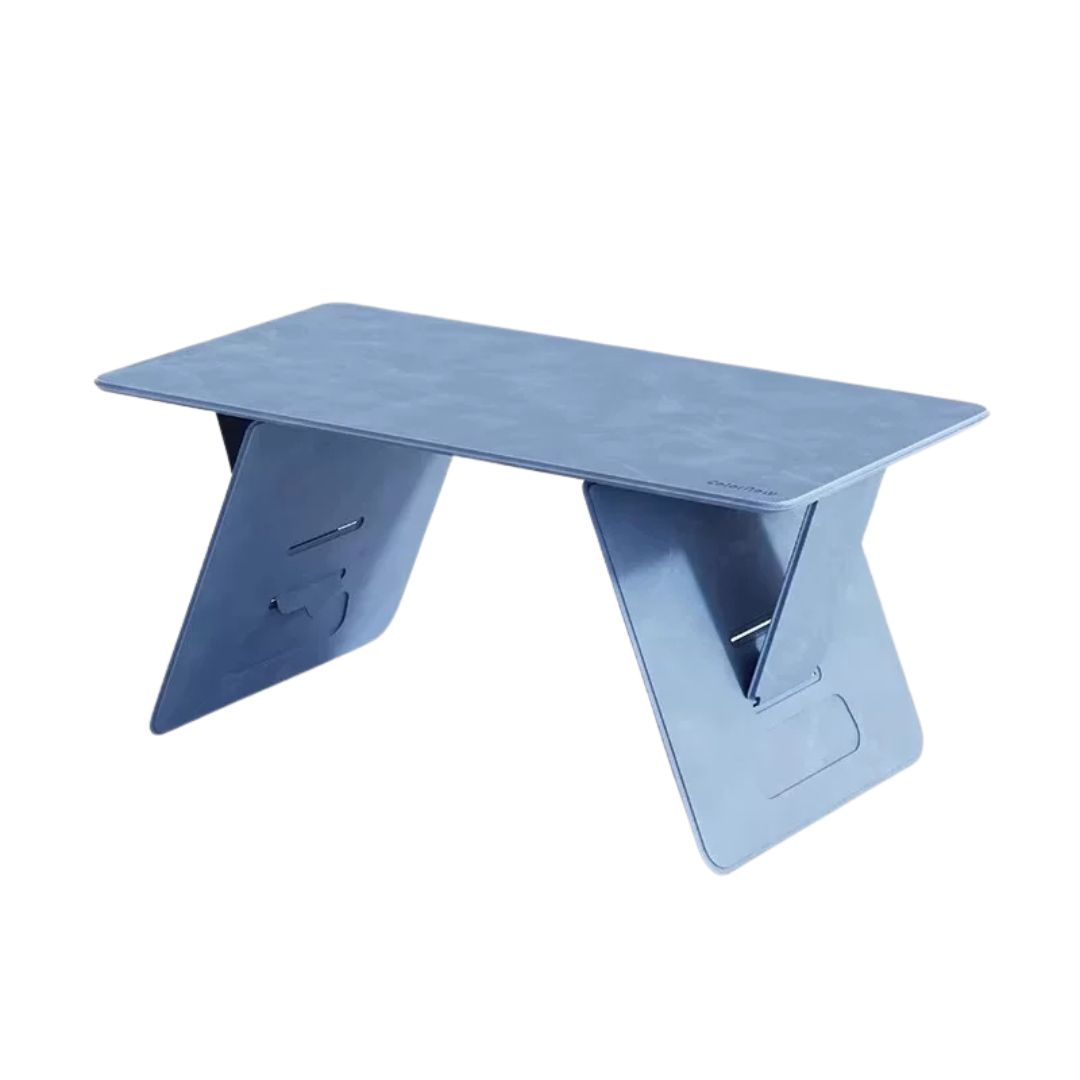 Blue leather folding lap desk draped with a soft blue throw on light neutral background