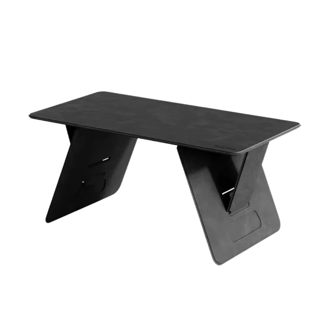 Person sliding blue folding lap desk into black leather backpack on caramel leather couch