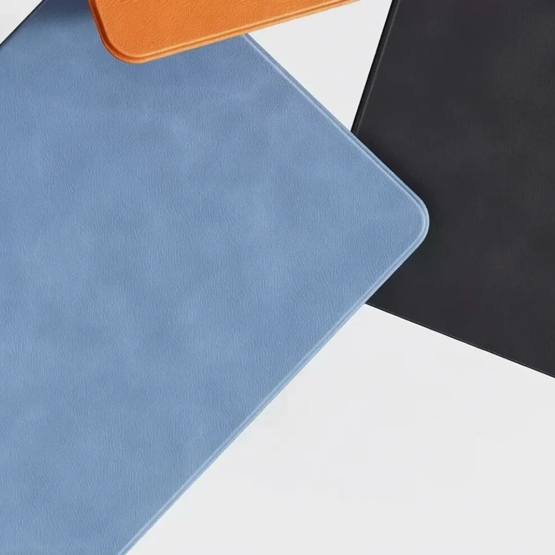 Close-up of blue, orange and black leather lap desk corners showing stitched edges and soft texture