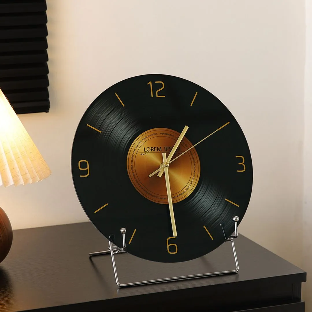 Black tempered glass vinyl-record clock with gold numerals styled beside red bunny figurine and white candle