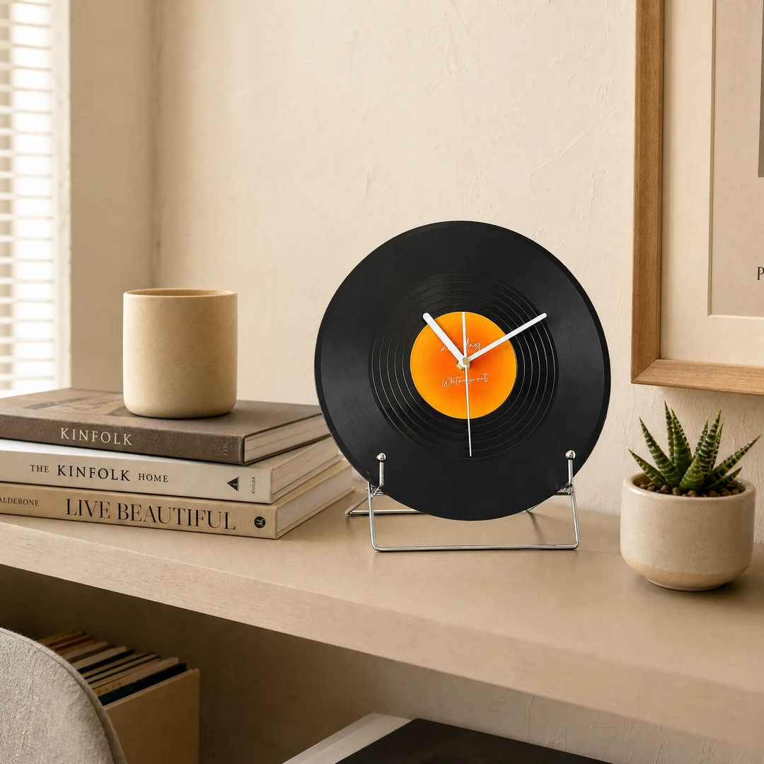 Retro vinyl desktop clock on beige shelf with books and succulent
