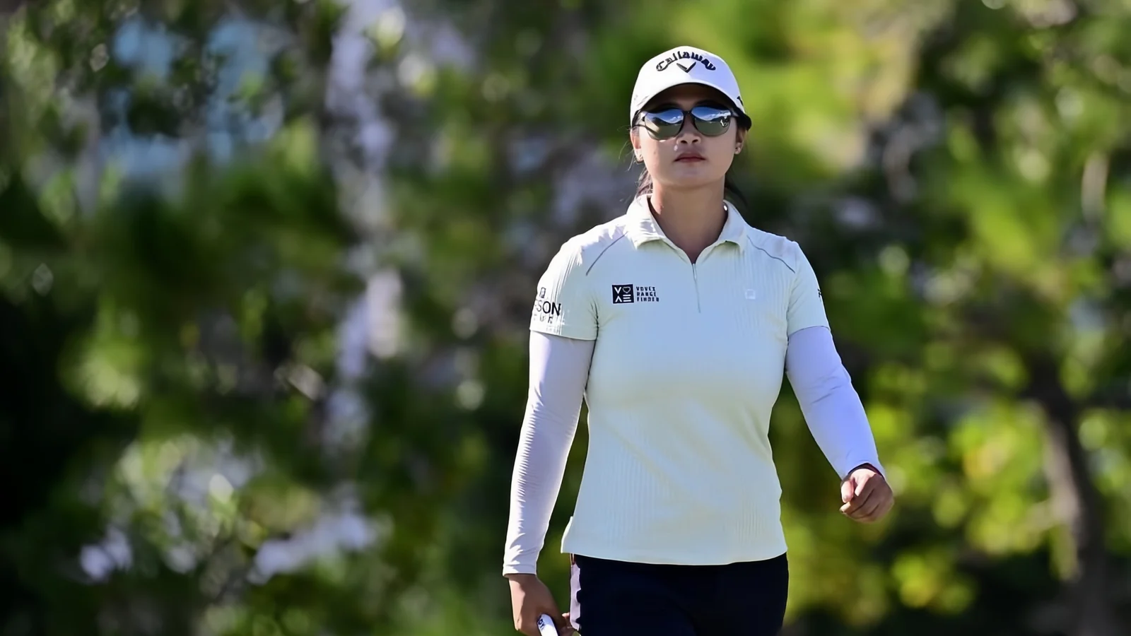 Liu Yan wearing USWING sunglasses while walking the golf course