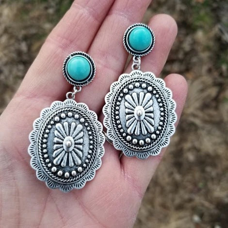 Turquoise-colored geometric concho cross earrings from Oroxen