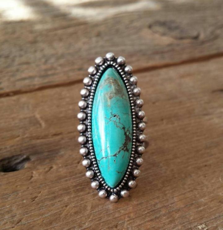 Turquoise vintage statement cross ring considered for a country concert outfit