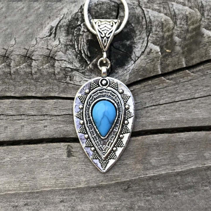 Teardrop pendant necklace used in a casual-to-dressy white shirt and jeans transition