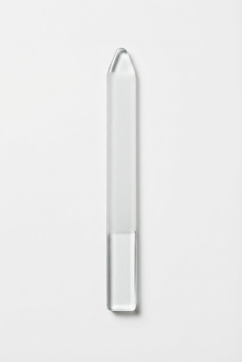 Minimal glass nail file on off-white background
