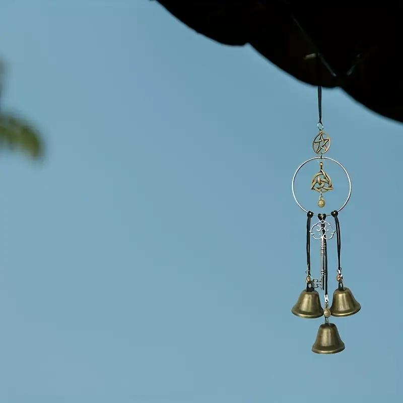 Handmade Rustic Witch Wind Chime hanging on wooden deck