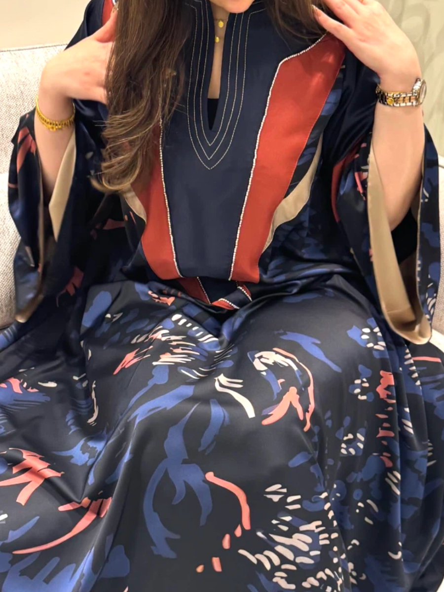 A luxurious abaya with a geometric design and intertwined flowers.