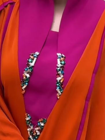 A luxurious abaya set in fuchsia and orange with elegant embroidery.