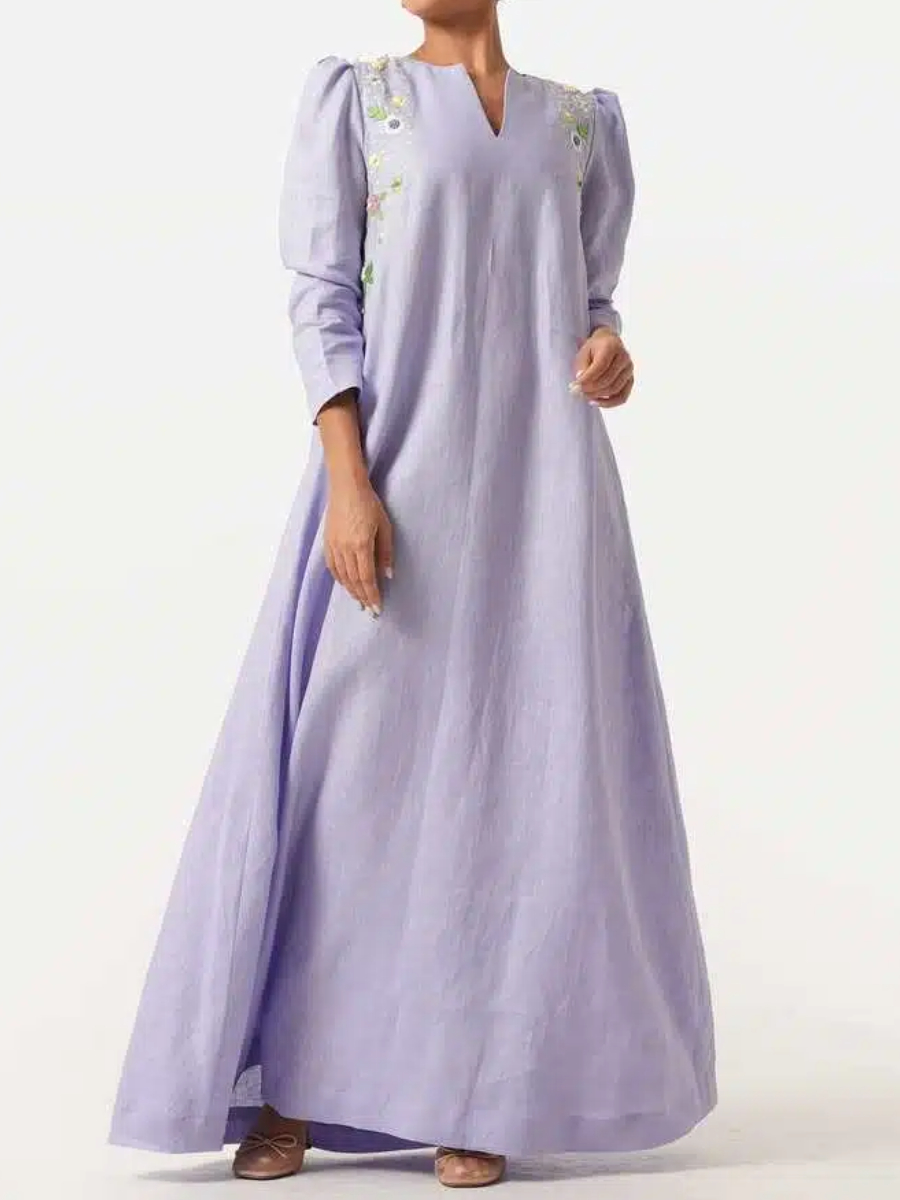 A long purple dress with elegant floral embroidery and puffed sleeves