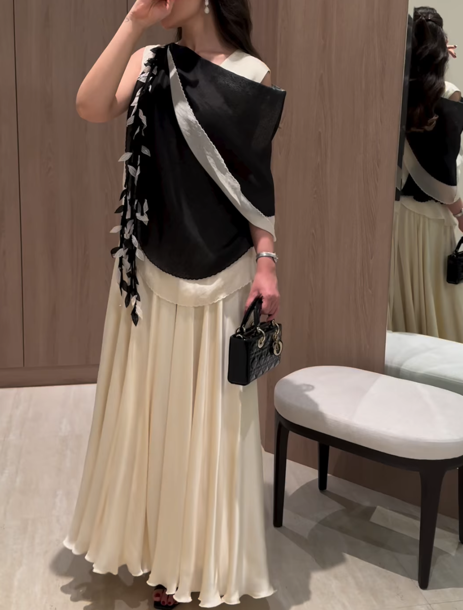 Elegant evening dress with a layered design and decorative details
