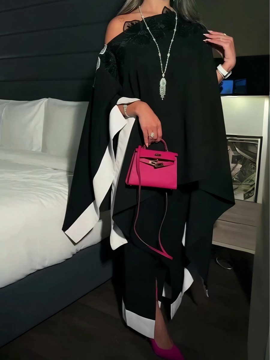 An elegant robe in blended colors, decorated with black and white floral patterns.