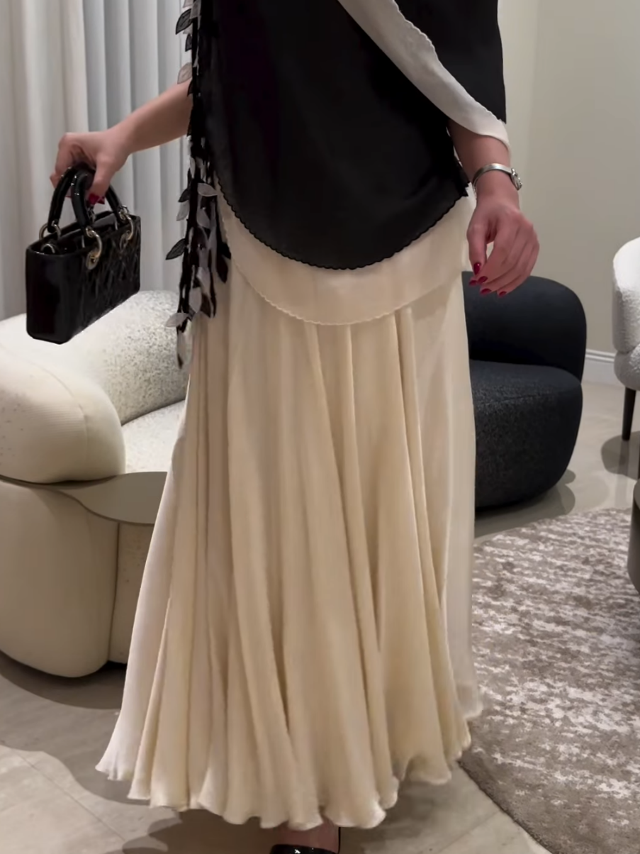 Elegant evening dress with a layered design and decorative details