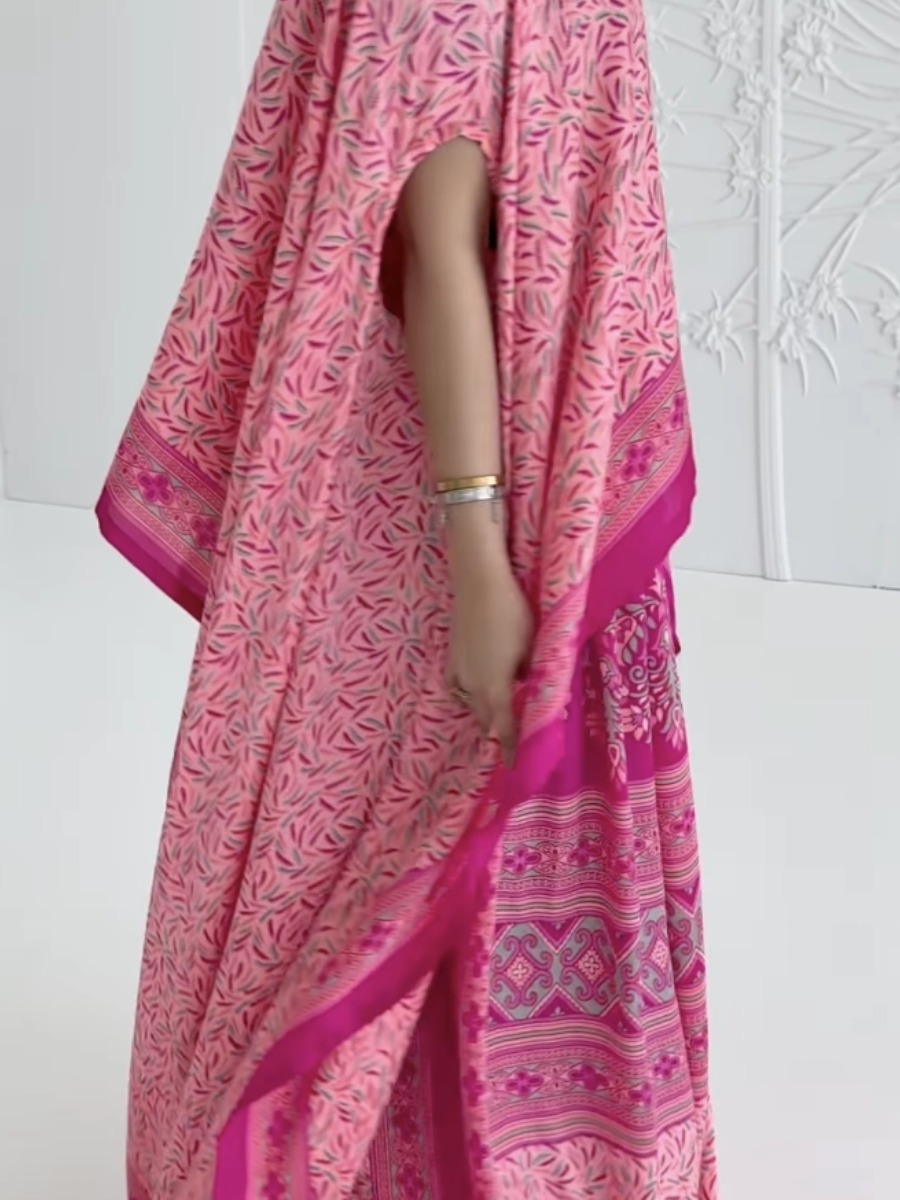 Elegant pink kaftan dress with a printed design