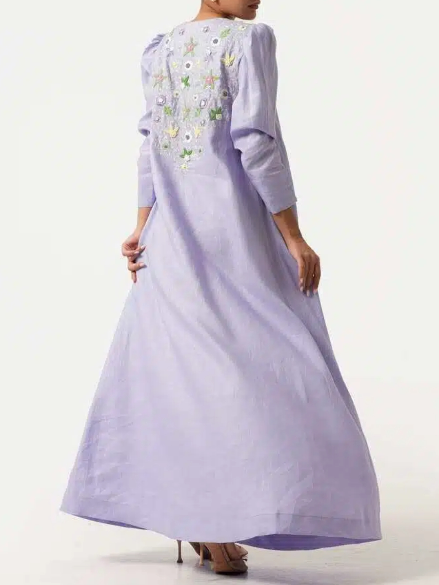 A long purple dress with elegant floral embroidery and puffed sleeves