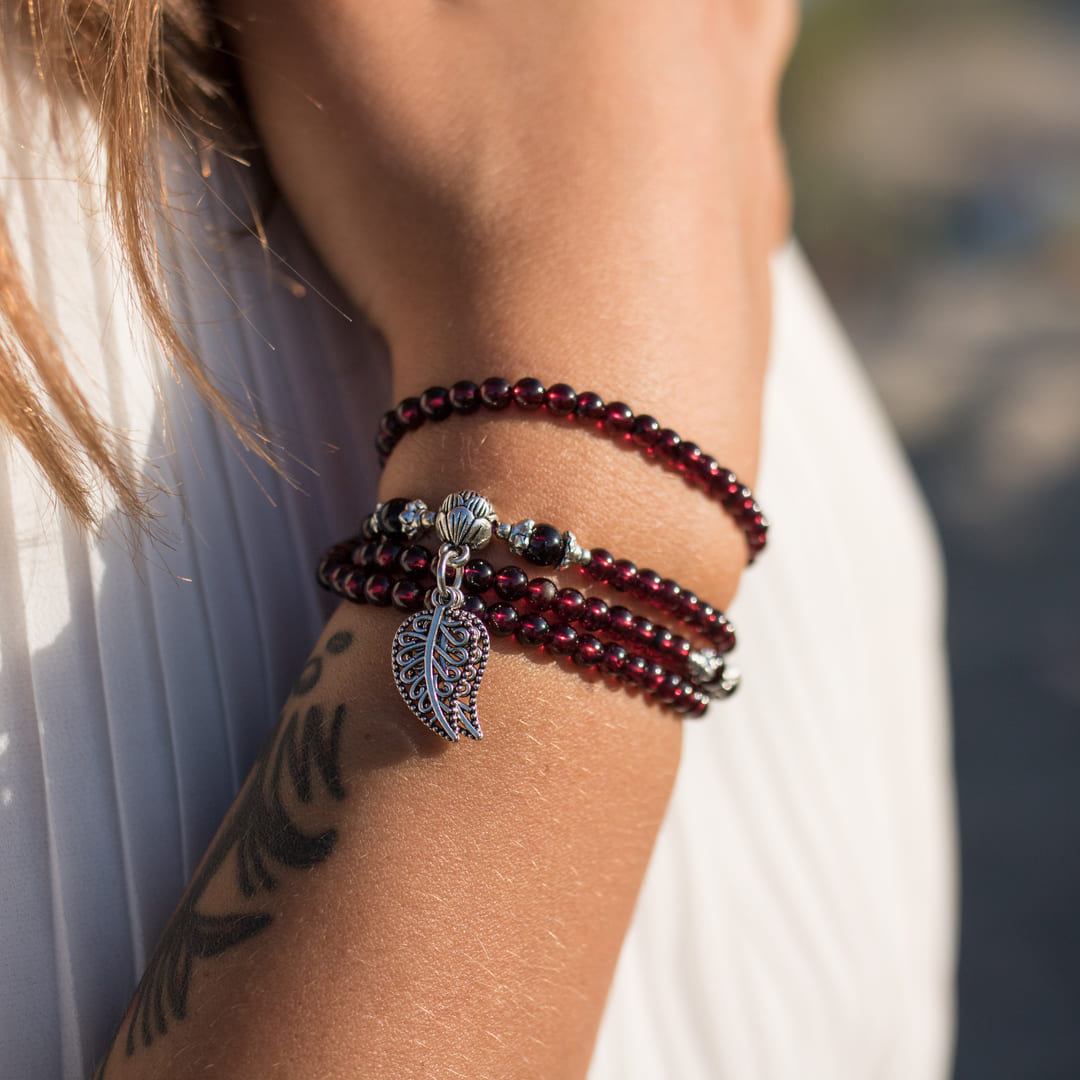 Close-up of the deep wine-colored Garnet beads on the bracelet