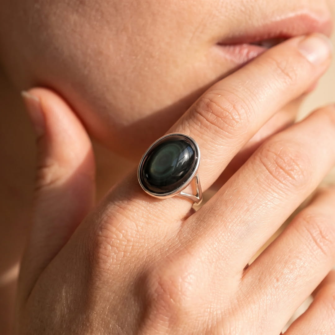 Close-up of the Celestial Eye Obsidian stone showing deep reflections - KARMAKIND
