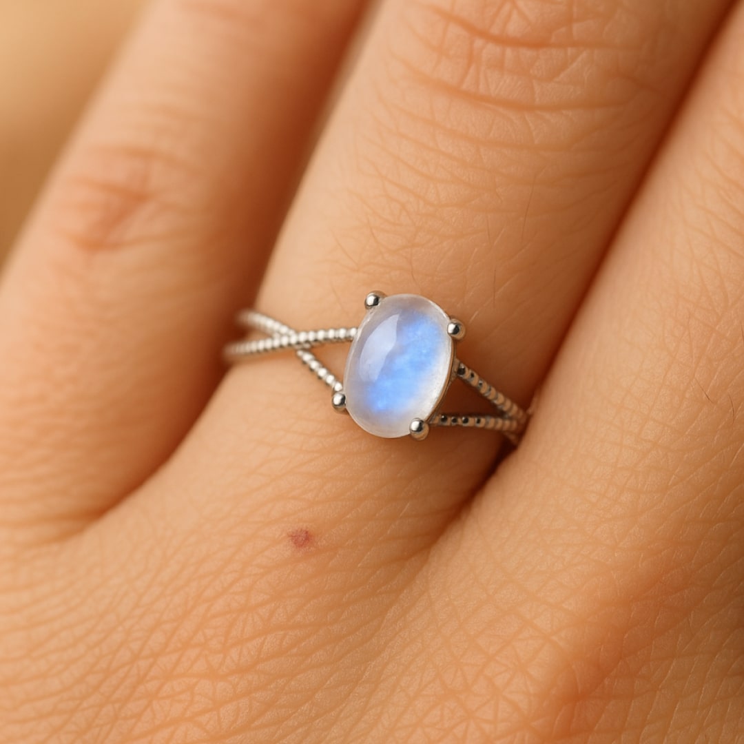 Moonstone ring on a finger, reflecting light - KARMAKIND