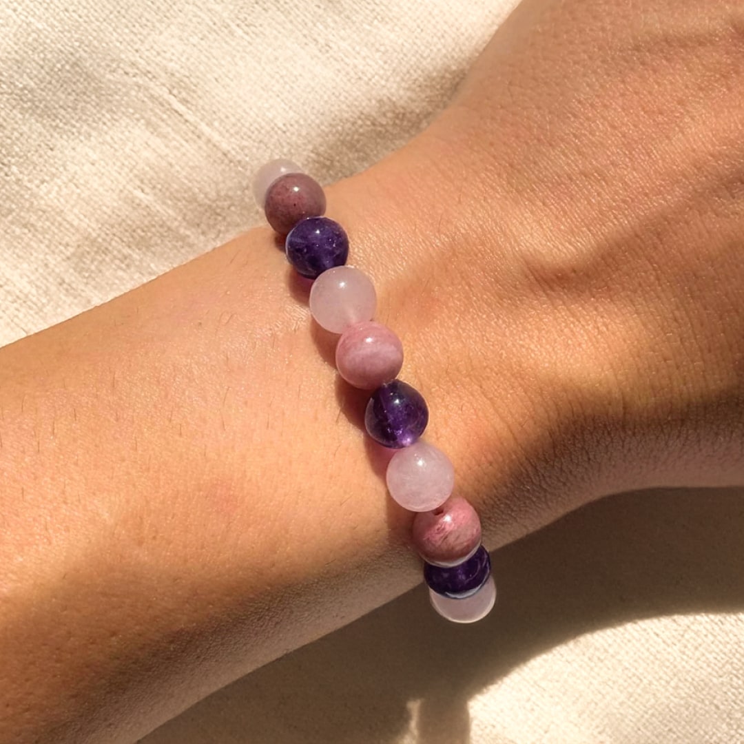 Close-up of the Rhodonite, Rose Quartz, and Amethyst beads on the Self-Love bracelet